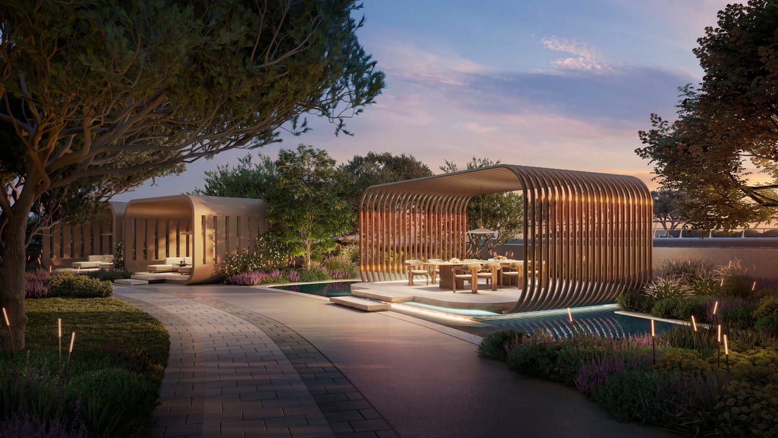 Outdoor business lounge on the landscaped podium at dusk, with a slatted pavilion, dining table and water feature