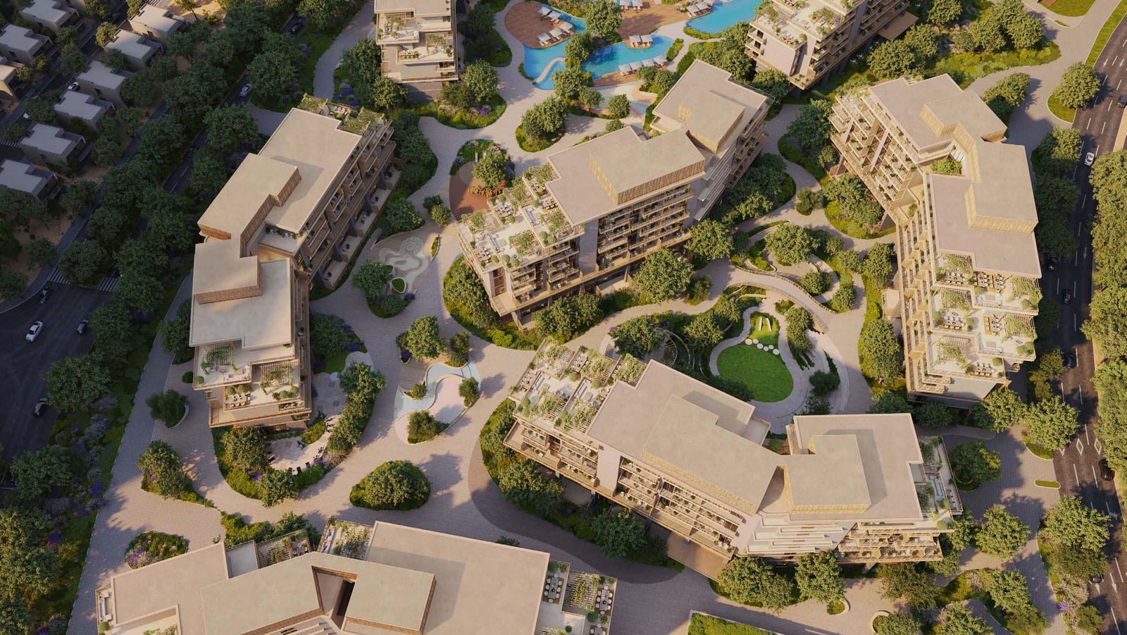 Aerial view of residential buildings with pale roofs set among gardens, paths and lawns