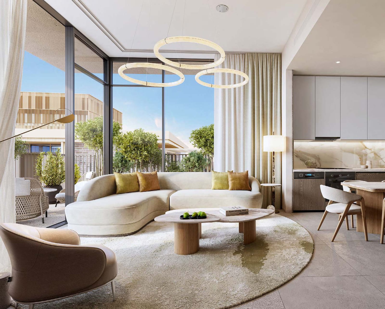 Living room with a curved white sofa, ring pendant light and open kitchen beside floor-to-ceiling windows