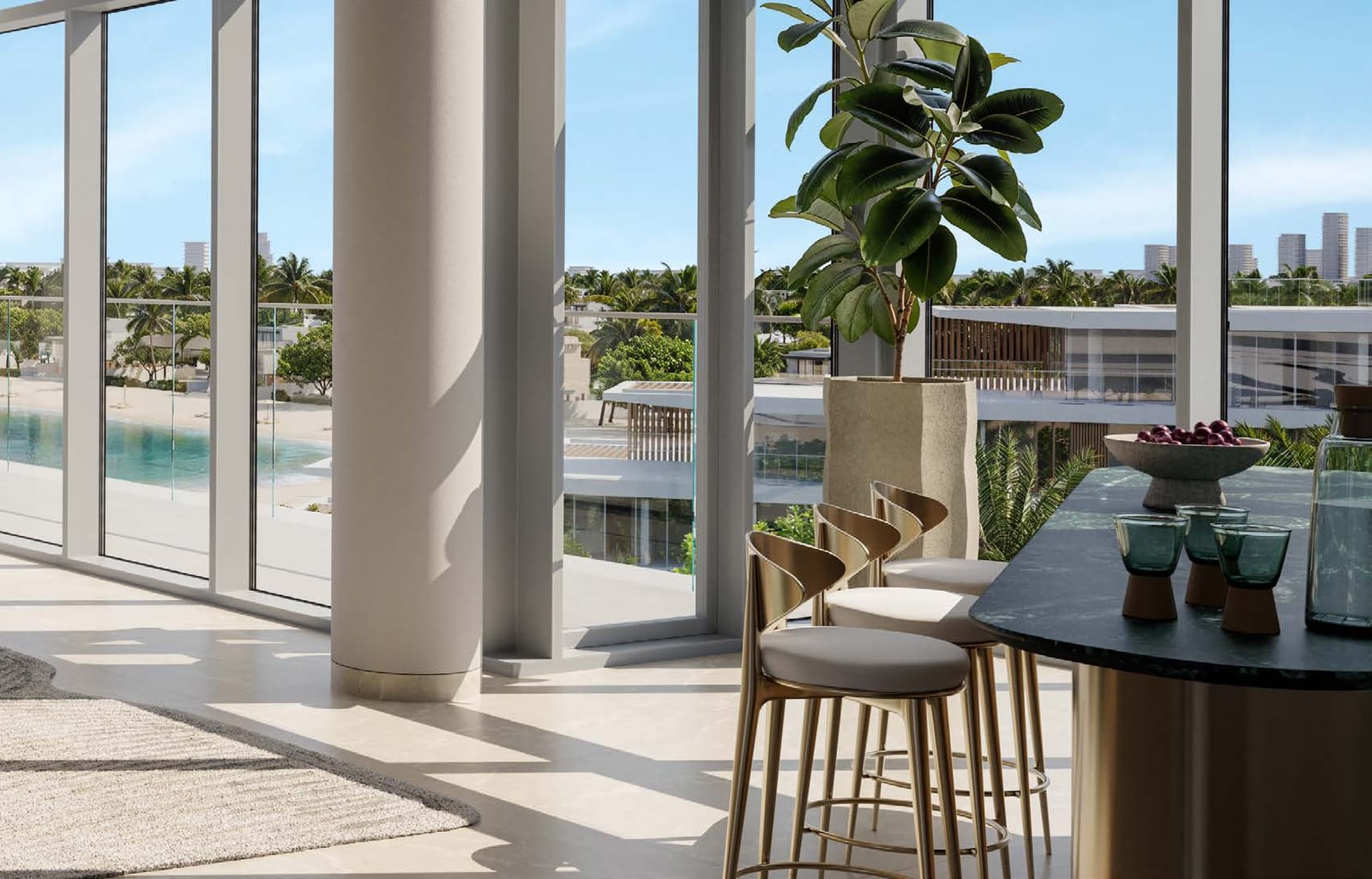 Kitchen bar with stools beside floor-to-ceiling windows overlooking the beach and neighbouring buildings