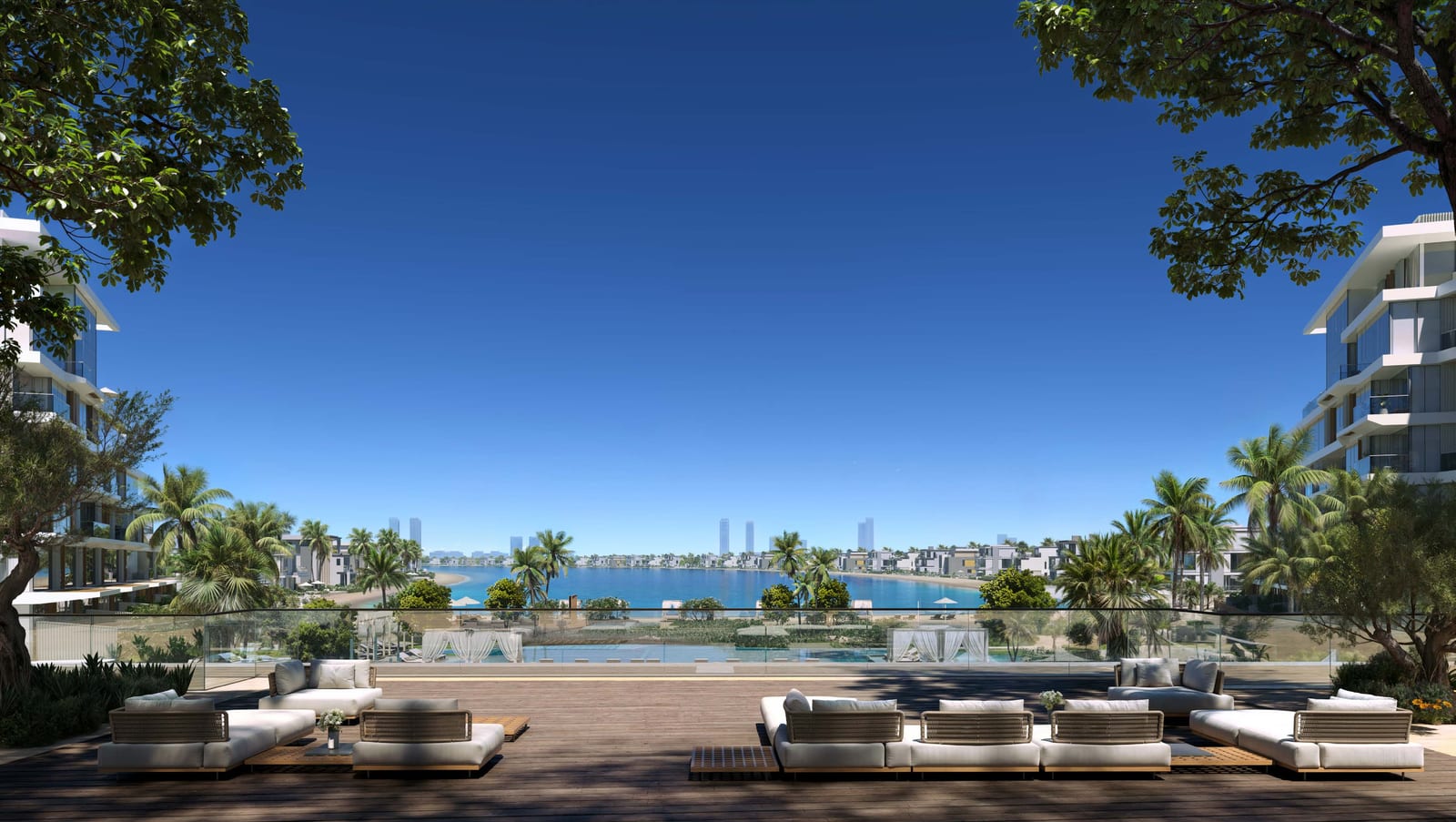 Pool deck with loungers and an infinity edge looking across the water to the skyline, framed by trees
