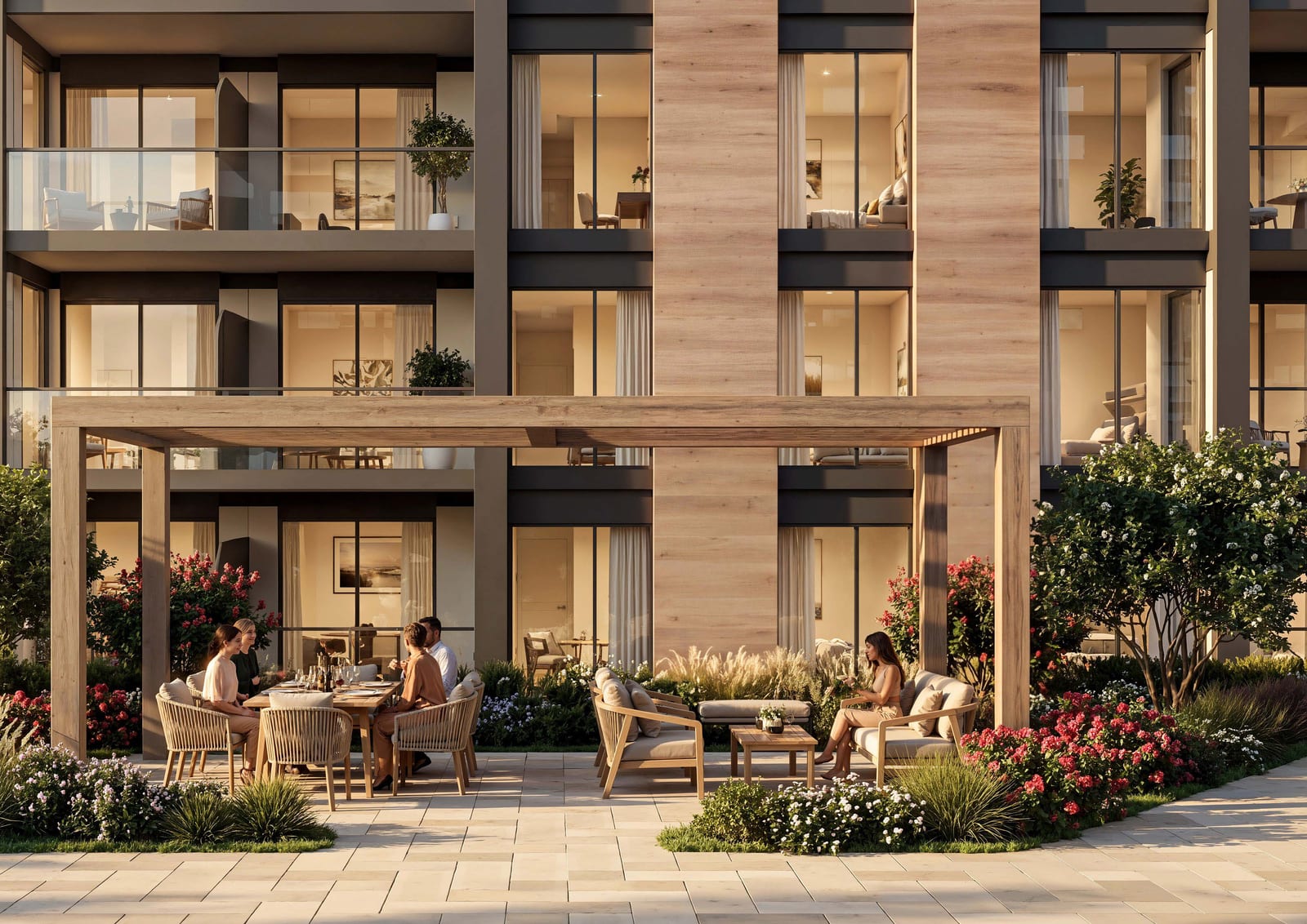 Ground-floor terrace under a timber pergola with a dining table and lounge seating, framed by flowering shrubs